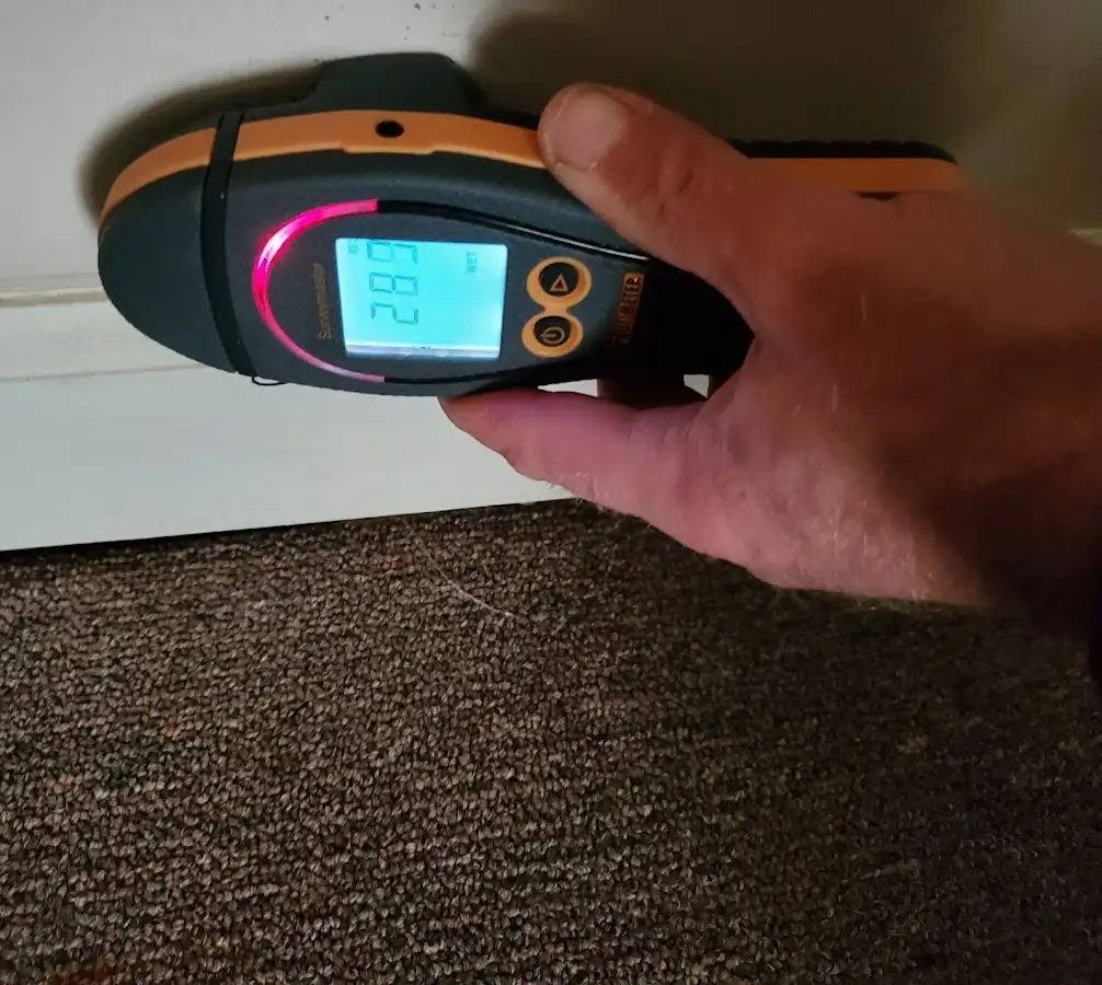 Moisture detection at baseboard during Storm Damage Restoration in Homestead Meadows North